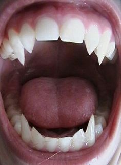 an open mouth with white teeth and long tongue is shown in this image, it appears to be very large