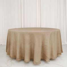 a round table with a beige cloth on it