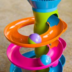 a stack of colorful plastic toys sitting on top of a floor