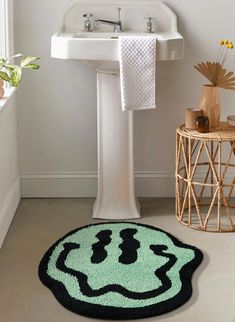 a bathroom with a sink, toilet and rug