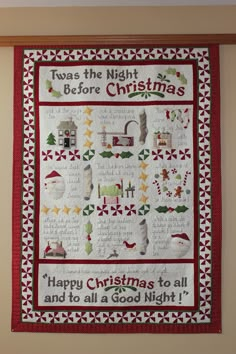 a christmas quilt hanging on the wall with words written in it and decorations around it