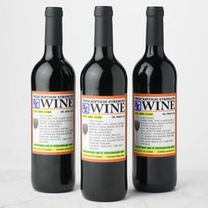 three bottles of wine sitting next to each other