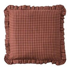 a brown and black plaid pillow with ruffles on the front, sitting on a white background