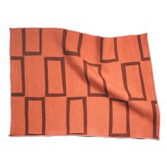 an orange and brown cloth with squares on it