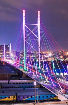 a bridge that is lit up with colorful lights