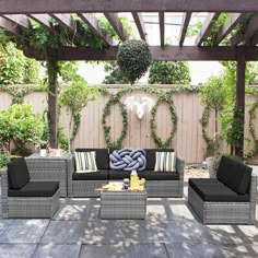 an outdoor living area with grey wicker furniture