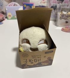 a stuffed animal in a box on a table