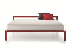 a red and white bed with two black pillows on it's headrests