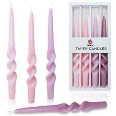 the pink candles are next to each other in their box and have long, curved tips