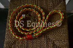 an orange, green and yellow lanyard with a metal hook