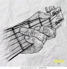 a hand holding a guitar string in front of a crumpled paper background with space for text