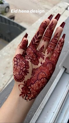 a woman's hand with henna designs on it