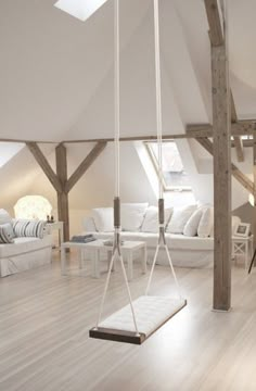 a living room with white furniture and wood beams on the ceiling is pictured in this image