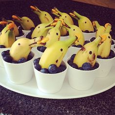 several cups with bananas and blueberries in them