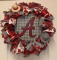 a red and white wreath with the letter a on it