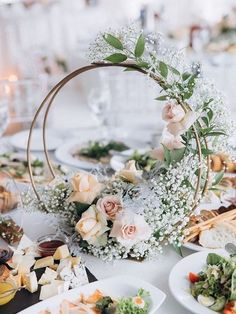 the table is set with flowers and plates