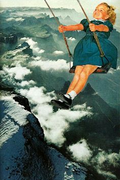 a woman is swinging on a rope above the clouds