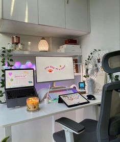 a desk with two laptops and a monitor on it