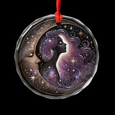 a glass ornament with a woman's face and stars in the background