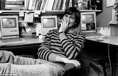 a man sitting in front of a computer desk