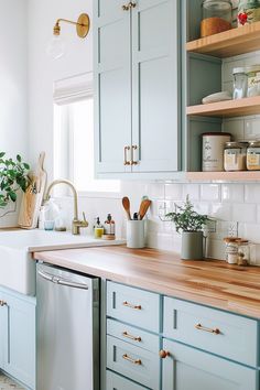 a kitchen with blue cabinets and wooden counter tops