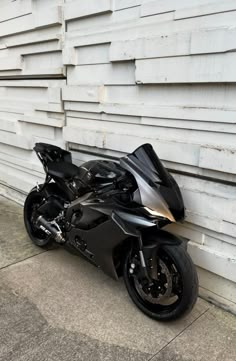 a black motorcycle parked in front of a white building