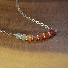 "This Gorgeous Mexican Fire Opal Necklace is presented to you in Sterling Silver. The beads are a moderate size, 4.25-4.5mm,  making for a lovely Everyday piece. The necklace displays the natural variety of Fire Opal in an Ombre fashion, with: soft whites, iridescent whites, yellows, oranges, and reds. In it, you will find beautiful speckles of rainbow flash. Fire Opal is associated with Abundance and Luck belongs to the Solar Plexus Chakra. It serves as the 14th Precious Stone Anniversary Gifts as well as the birthstone for the month of October >Mexican Opal, October Birthstone Necklace, Christmas, Mexican Fire Opal, Opal Jewelry, Ethical Opal, October Birthstone, Minimalist Opal, Orange Opal Necklace, Minimalist gemstone necklace, Summer necklace DETAILS: >Necklace can be made of High Qu Necklace Displays, October Birthstone Necklace, 14th Anniversary, Fire Opals Jewelry, Fire Opal Necklace, Mexican Fire Opal, Ombre Fashion, Solar Plexus Chakra, Summer Necklace