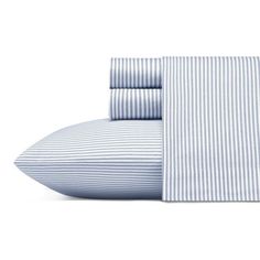 the blue and white striped sheets are folded on top of each other, with two pillow cases