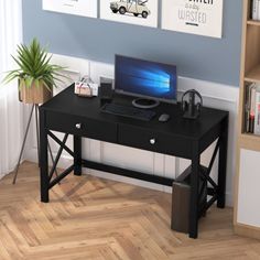 a black computer desk with a laptop on it