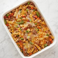 a casserole dish filled with pasta and vegetables