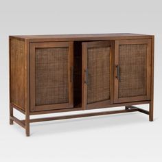 a wooden cabinet with wicker doors and handles