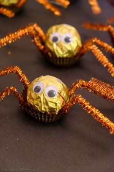 some chocolate covered cupcakes with googly eyes and orange streamers on them