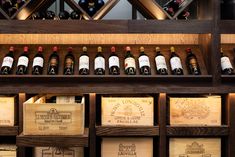 wine bottles are lined up on wooden crates