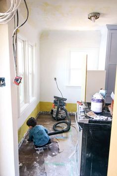 a man is working on the floor in a room