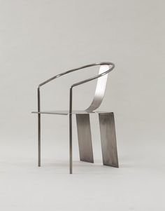 a metal chair sitting on top of a white floor