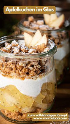 two glass jars filled with food on top of a wooden table