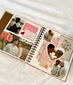 an open wedding album with pictures of people and flowers on the pages, sitting on a white sheet