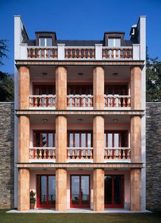 an apartment building with balconies on the second floor