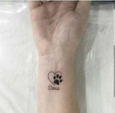 a dog paw and heart tattoo on the wrist