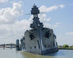 a large battleship floating on top of a body of water