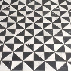 a black and white tiled floor with triangles