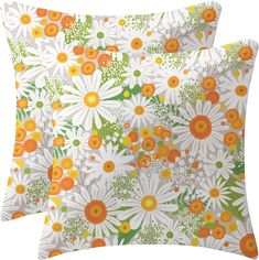 two pillows with orange and white flowers on them