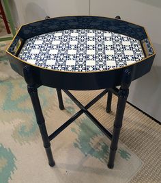 a blue and white tray sitting on top of a wooden table next to a rug