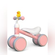 a pink tricycle with a rubber ducky on the handle