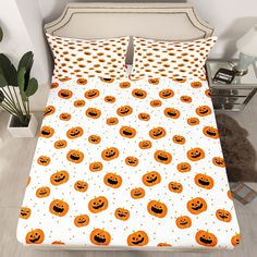 a bed with pumpkins and polka dots on it