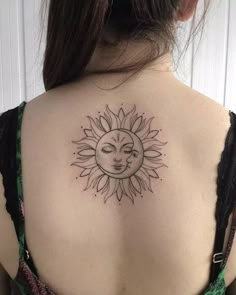 a woman with a sun tattoo on her back