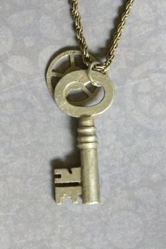 You don't often see antique keys in this style and condition. We've had to buy up a few at auction in England to get the quality and shape desired, but when the right antique key is found, it's the perfect subject for a curious and trendy pendant. Steampunk fans won't want to miss this old beauty. This elegant retro Victorian style pendant has all the grace and charm one could want along with the real nostalgic mystery of an unknown history. We've added a muted silver tone finished Steampunk sty Vintage Metal Key Jewelry, Vintage Metal Jewelry With Keys Detail, Vintage Metal Jewelry With Keys, Vintage Brass Necklaces With Two Keys, Vintage Gold Jewelry With Keys, Vintage Metal Jewelry With Two Keys, Vintage Gold Key Necklace, Vintage Gold Necklaces With Keys, Old Beauty