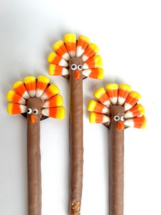 three sticks with fake turkeys on them are arranged in the shape of two trees