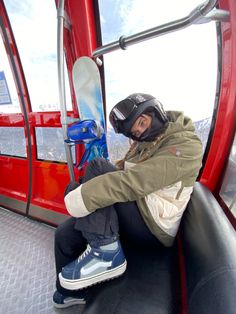 a person sitting on top of a ski lift