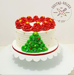 a white cake with red frosting and green decorations